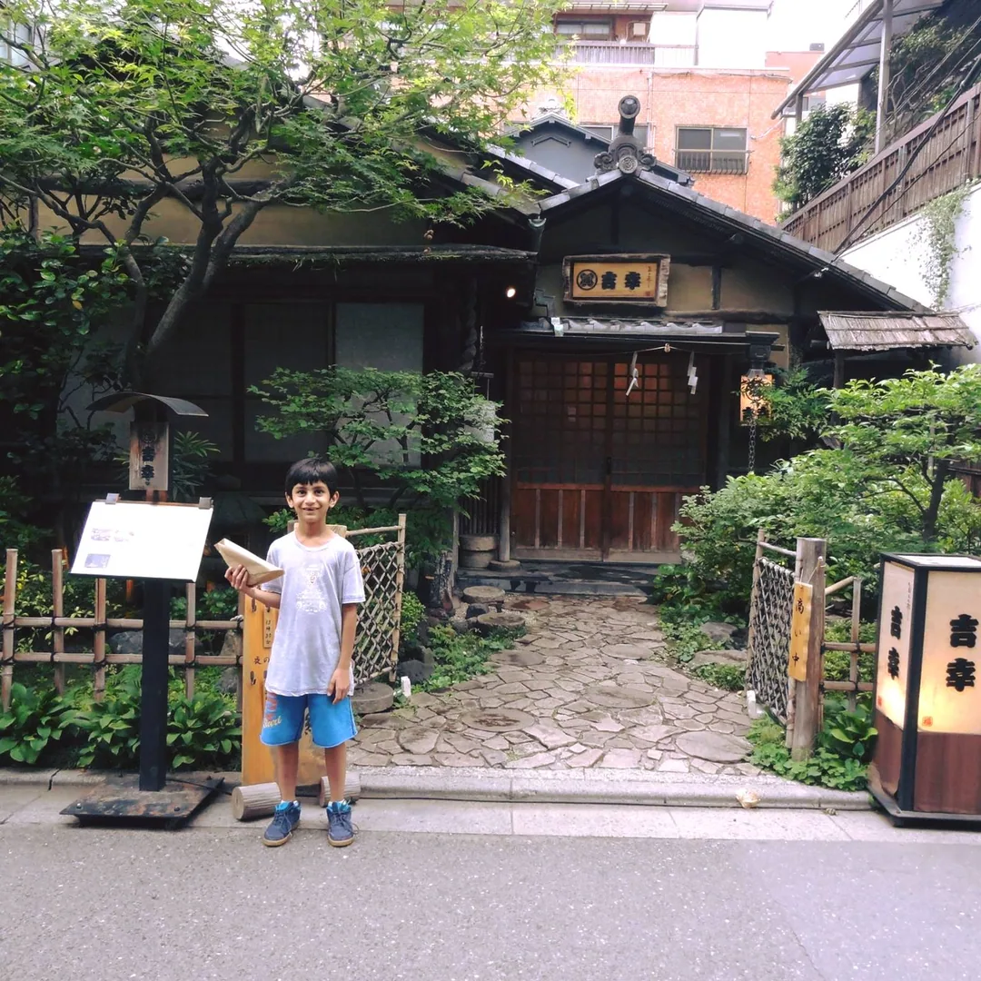 Here I am with a toothless grin, munching on my roadside snack outside a fancy restaurant.