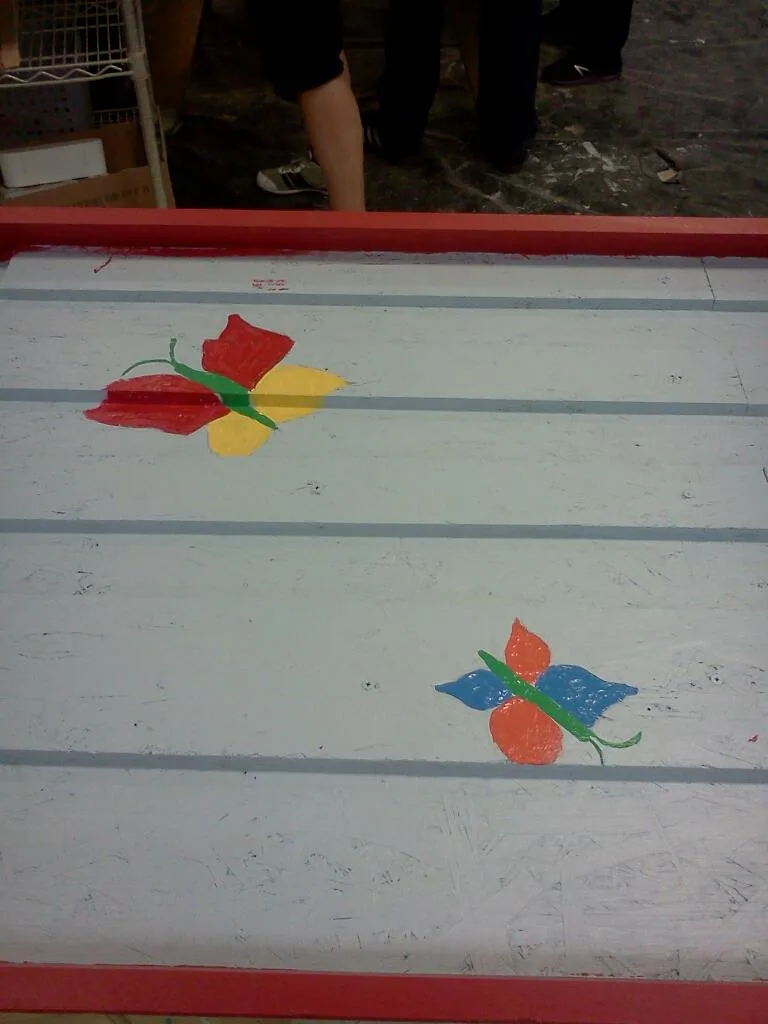 Painting butterflies on a playhouse