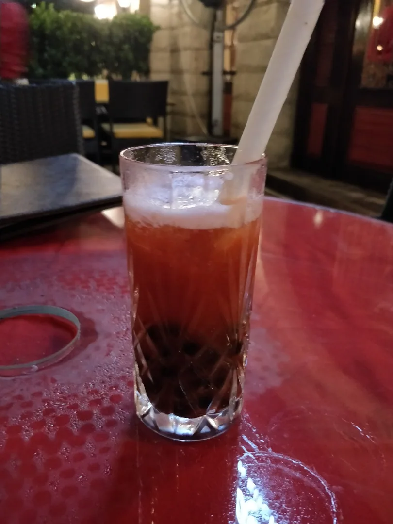 First of all, who serves Boba Tea in a crystal glass?

And why are the pearls so thick and chewy? They should be like bu