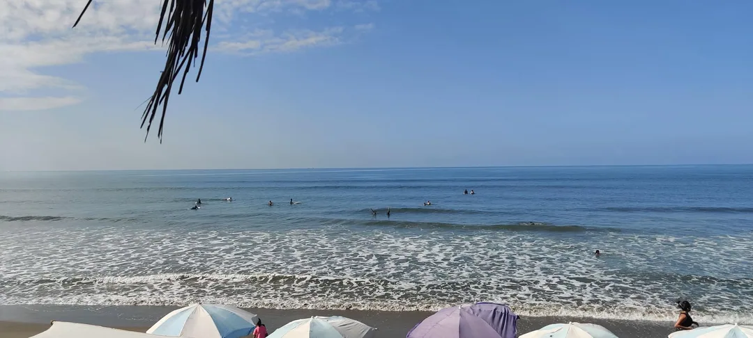 It's a good day to be out at the beach. There's a cool breeze blowing, and the sun is behind the clouds. We are surfing 