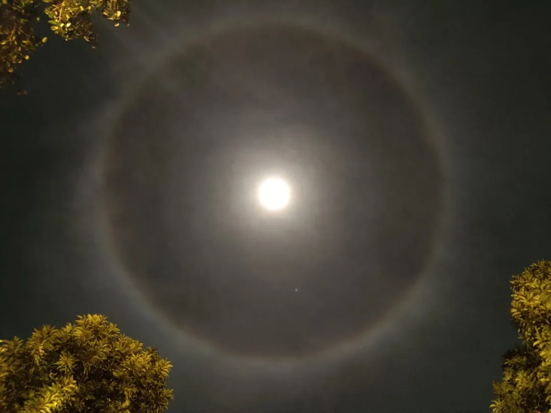 The sky above Dabolim right now. There's a ring around the moon. If you zoom in, you'll see it's a rainbow.