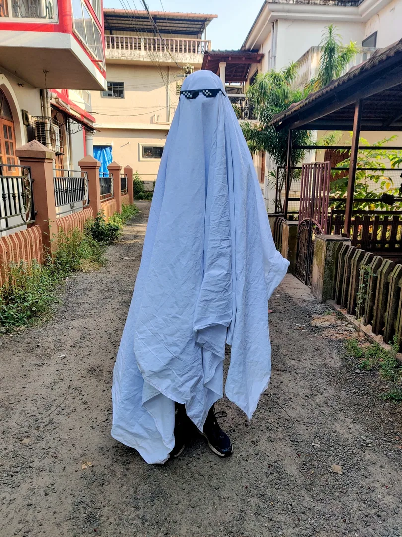 With the hands down, it's an Arab person who has lost their way.

How is this a ghost? The meme glasses are destroying t
