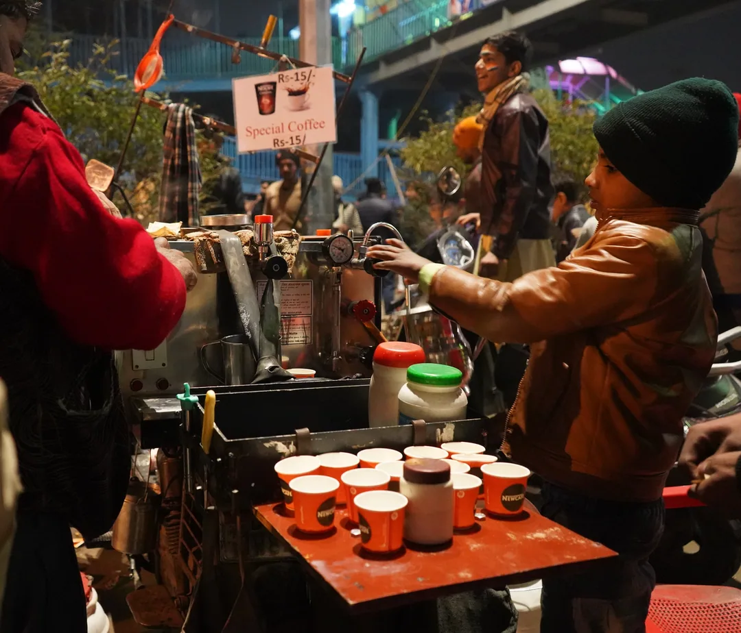 The street vendors, selling their wares under the massive street over bridge. The crowd of idle onlookers like me brings