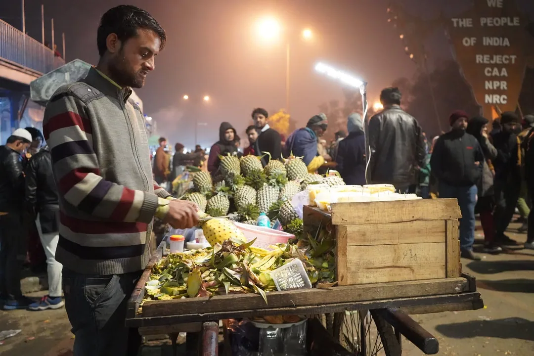 The street vendors, selling their wares under the massive street over bridge. The crowd of idle onlookers like me brings