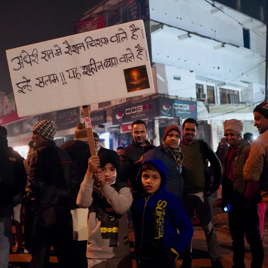 Do these cute kids understand the message on their board?

I suppose the detention center, an art Installation and popul