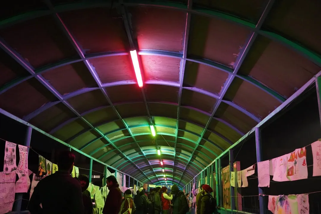 Someone has coloured the tubelights of the foot over bridge. The bridge roof now glows in psychedelic colours at night.