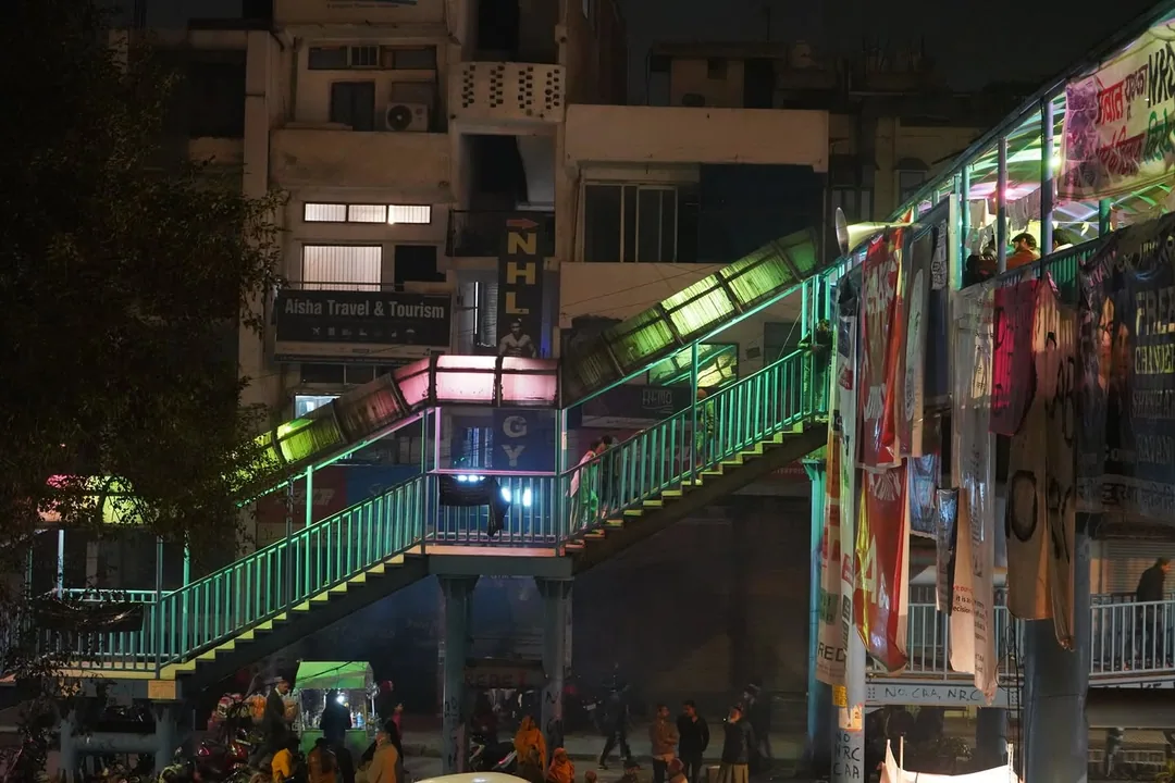 Someone has coloured the tubelights of the foot over bridge. The bridge roof now glows in psychedelic colours at night.