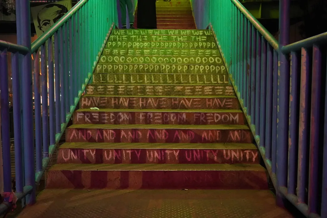 Someone has coloured the tubelights of the foot over bridge. The bridge roof now glows in psychedelic colours at night.