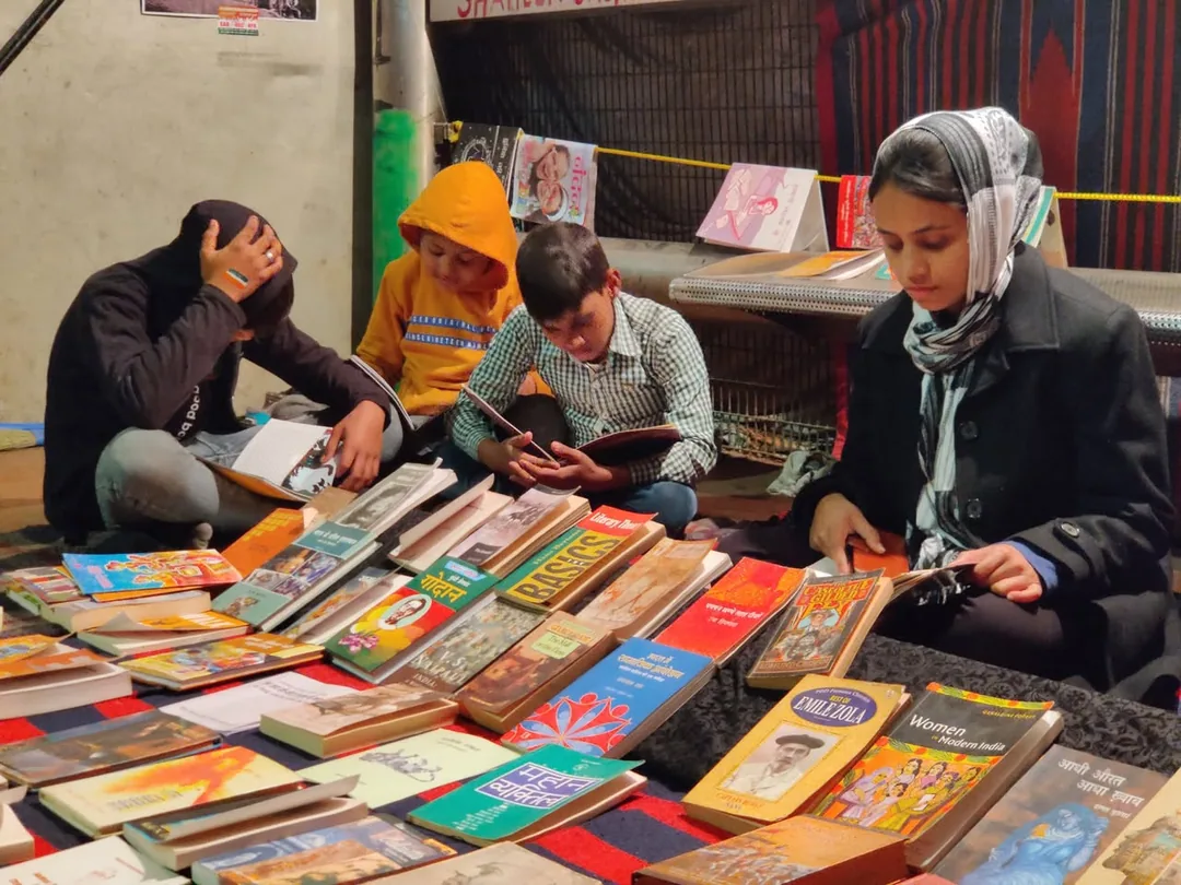More books. And people sitting and reading amidst the nonstop din and tamasha right in front of their library.