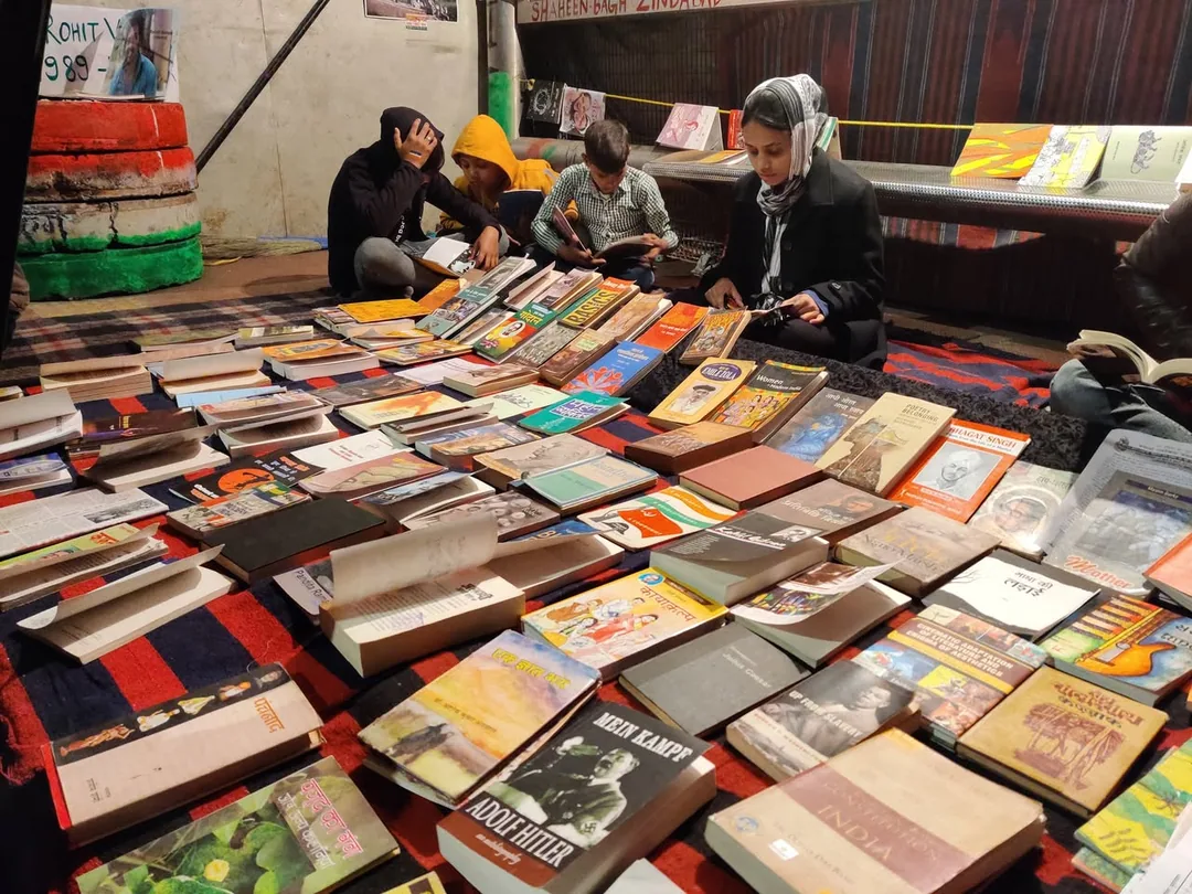 More books. And people sitting and reading amidst the nonstop din and tamasha right in front of their library.